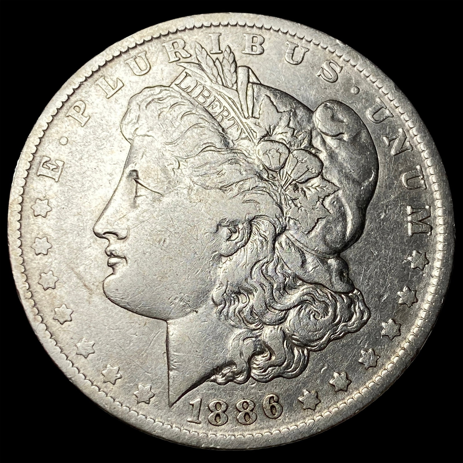 1886-O Silver Morgan Dollar ABOUT UNCIRCULATED