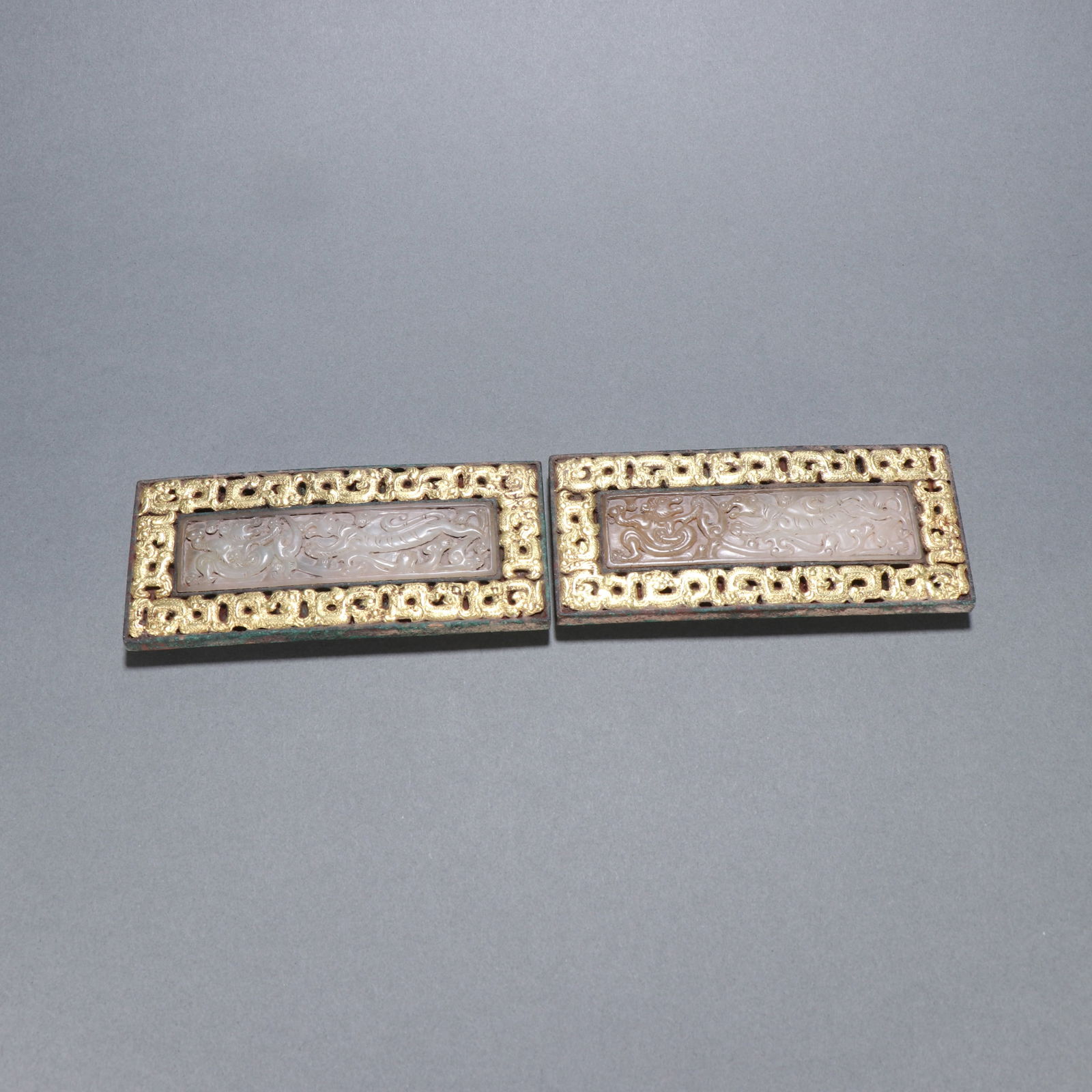 A pair of Han Dynasty gilt bronze belt buckles inlaid with jade (1 of 2)