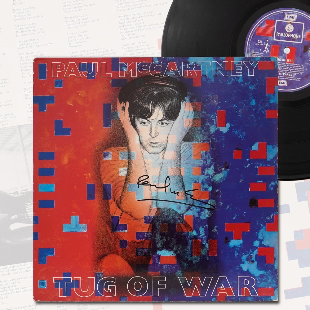 PAUL MCCARTNEY SIGNED "TUG OF WAR" VINYL RECORD ALBUM (1982): 12 1/4 x 12 1/4 in Provenance and authentication: This collectible has undergone a rigorous forensic evaluation. The signatures were carefully analyzed across multiple criteria, including ink depositi