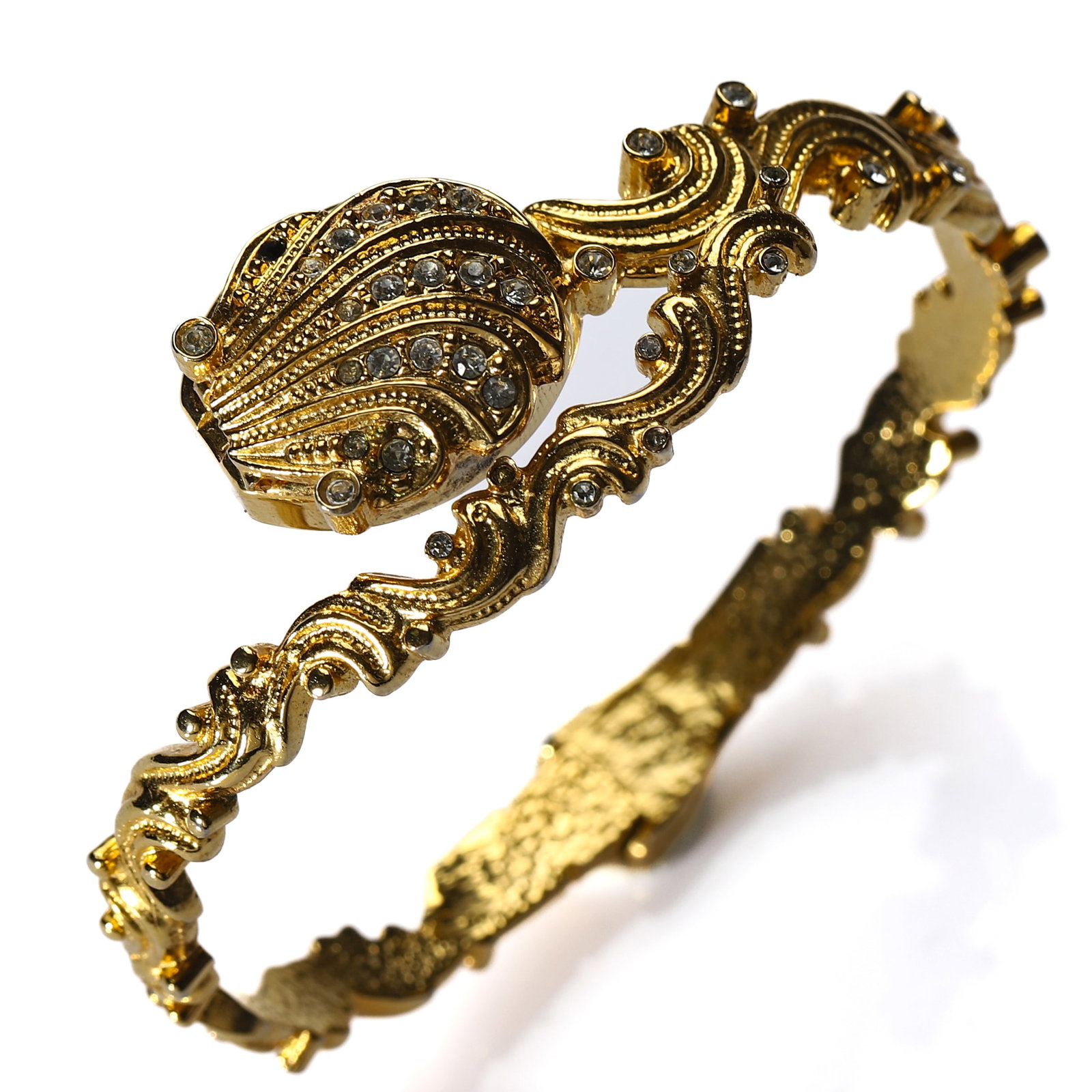 WINKS QUARTZ BANGLE WATCH: Dimensions Inner Diameter: 2 5/16 in (58 mm) Description A gilt-tone Winks quartz bangle watch with hinged cover and ornate openwork bracelet. The circular case enclosing a champagne dial signed "Wink