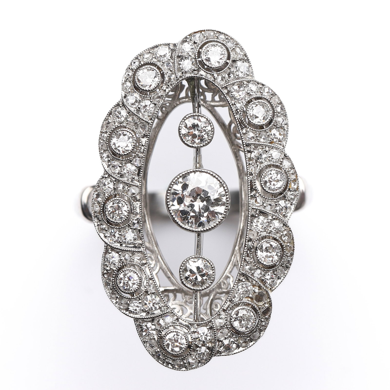 AN ART DECO-STYLE DIAMOND PLAQUE RING: Dimensions Inner diameter 18.5 mm; face 1 3/16 × 11/16 in (30.1 × 18.3 mm); weight approx. 10 g. Description: Of elongated openwork plaque design, centering a round brilliant-cut diamond flanked by 