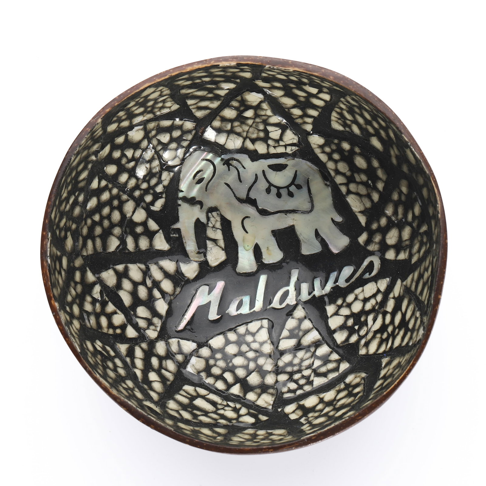 A HANDCRAFTED COCONUT SHELL BOWL WITH MOTHER-OF-PEARL INLAY, MALDIVES: Dimensions Diameter 4 7/8 in (12.5 cm); Height 2 3/4 in (7 cm); Weight: 81.7 g Description:?A decorative coconut shell bowl intricately inlaid with mosaic-patterned mother-of-pearl pieces forming a