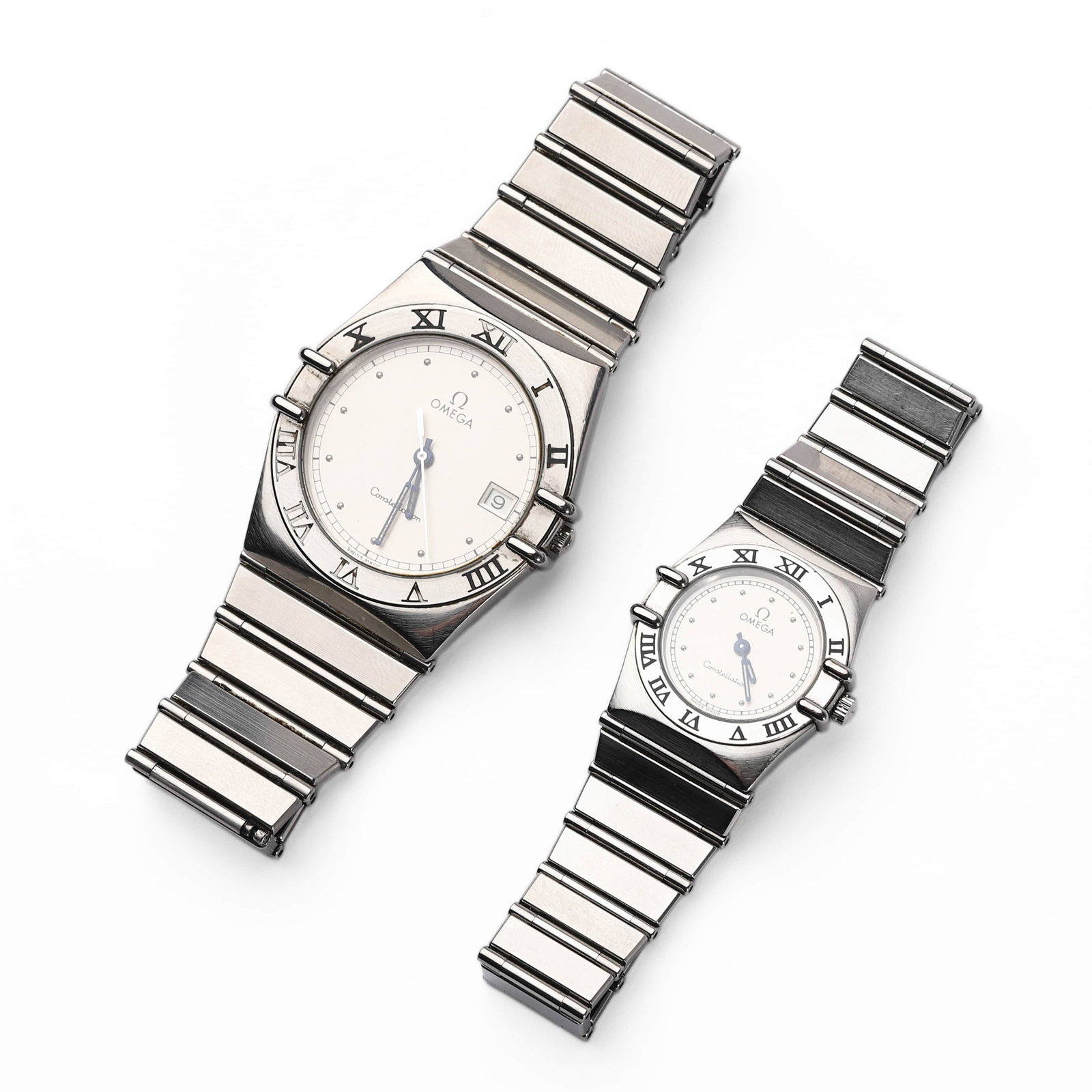 PAIR OF OMEGA CONSTELLATION STAINLESS STEEL QUARTZ WRISTWATCHES: Dimensions Gents: Dial diameter 1 5/16 in. (33.7 mm)Ladies: Dial diameter 31/32 in. (24.5 mm) Description A matching pair of Omega Constellation wristwatches in stainless steel, each with a white dial