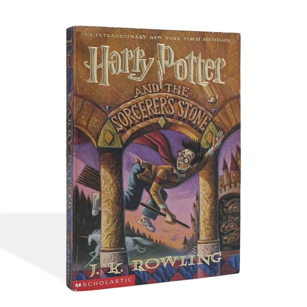 J. K. ROWLING SIGNED HARRY POTTER AND THE SORCERER'S STONE: 8 1/8 x 5 3/8 in (20.5 x 13.6 cm) Harry Potter and the Sorcerer's Stone introduced readers to the wizarding world that would become one of the most influential literary franchises of the modern era.