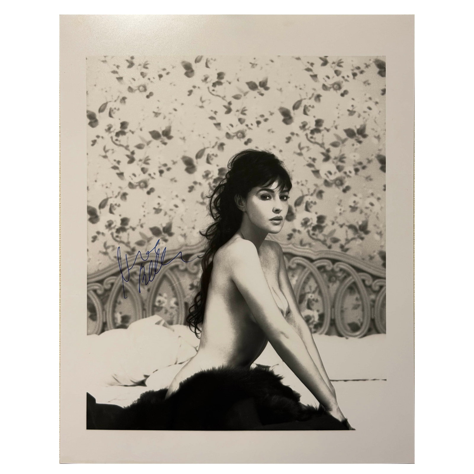 MONICA BELLUCCI, SIGNED PORTRAIT, CIRCA 1990S: Signed Portrait, circa 1990s Gelatin silver print, signed "Monica Bellucci" in blue ink on the image Dimensions: 7 7/8 × 9 7/8 in. (20 × 25 cm) Description: An elegant black-and-white portrait of th