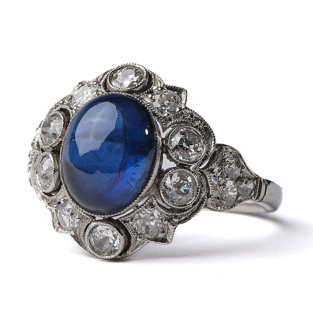 ART DECO PLATINUM DIAMOND AND 3.5-CARAT SAPPHIRE RING: An exquisite Art Deco period (1925-1935) Italian aristocratic custom-made platinum ring featuring a stunning 3.5-carat natural sapphire at its center, measuring 3/8 × 5/16 in. (10 × 8 mm).