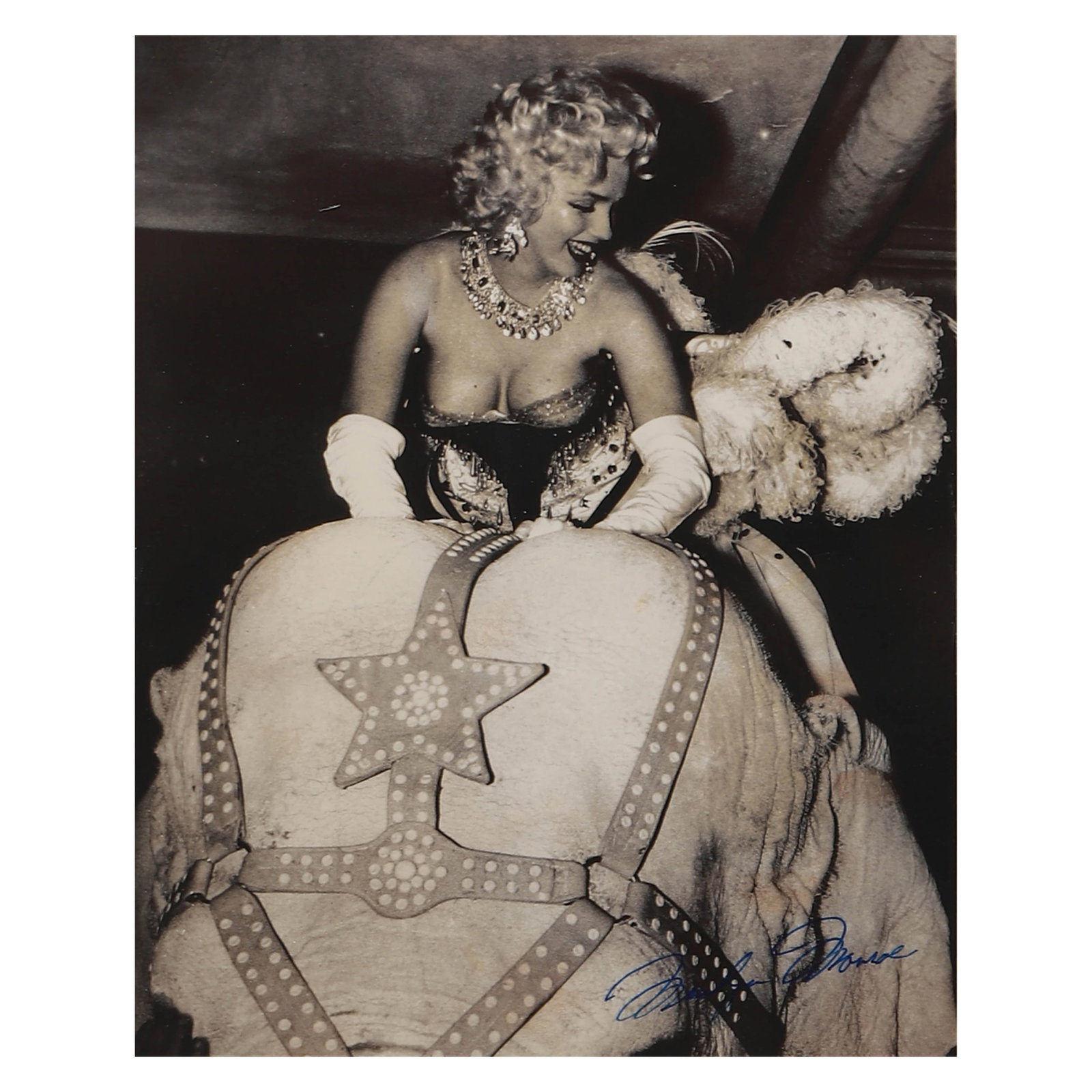 WEEGEE (ARTHUR FELIG) (1899–1968)?Marilyn Monroe, circa 1955: Description Title: Marilyn Monroe on Circus Elephant Period: Circa 1955 Materials: Gelatin silver print by Weegee, inscribed "Marilyn Monroe" in blue ink on the recto Size: Photograph 9 1/4 × 7 7/16