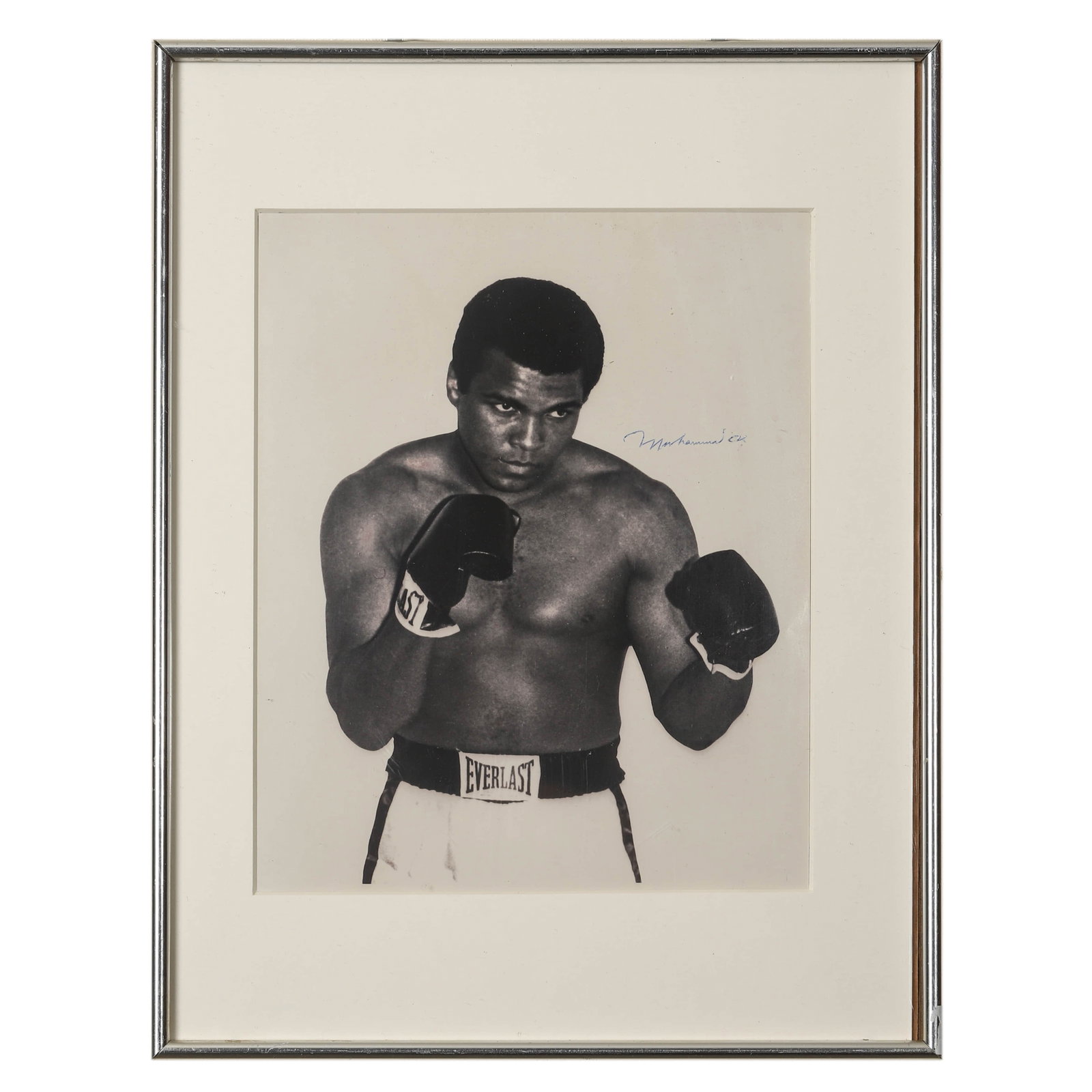 PORTRAIT OF MUHAMMAD ALI, CIRCA 1970S: Portrait of Muhammad Ali, circa 1970s Gelatin silver print, signed "Muhammad Ali" in blue ink (upper right) Dimensions: Frame 16 1/2 × 12 3/4 in. (42 × 32.3 cm) Description: A striking black-and-whi