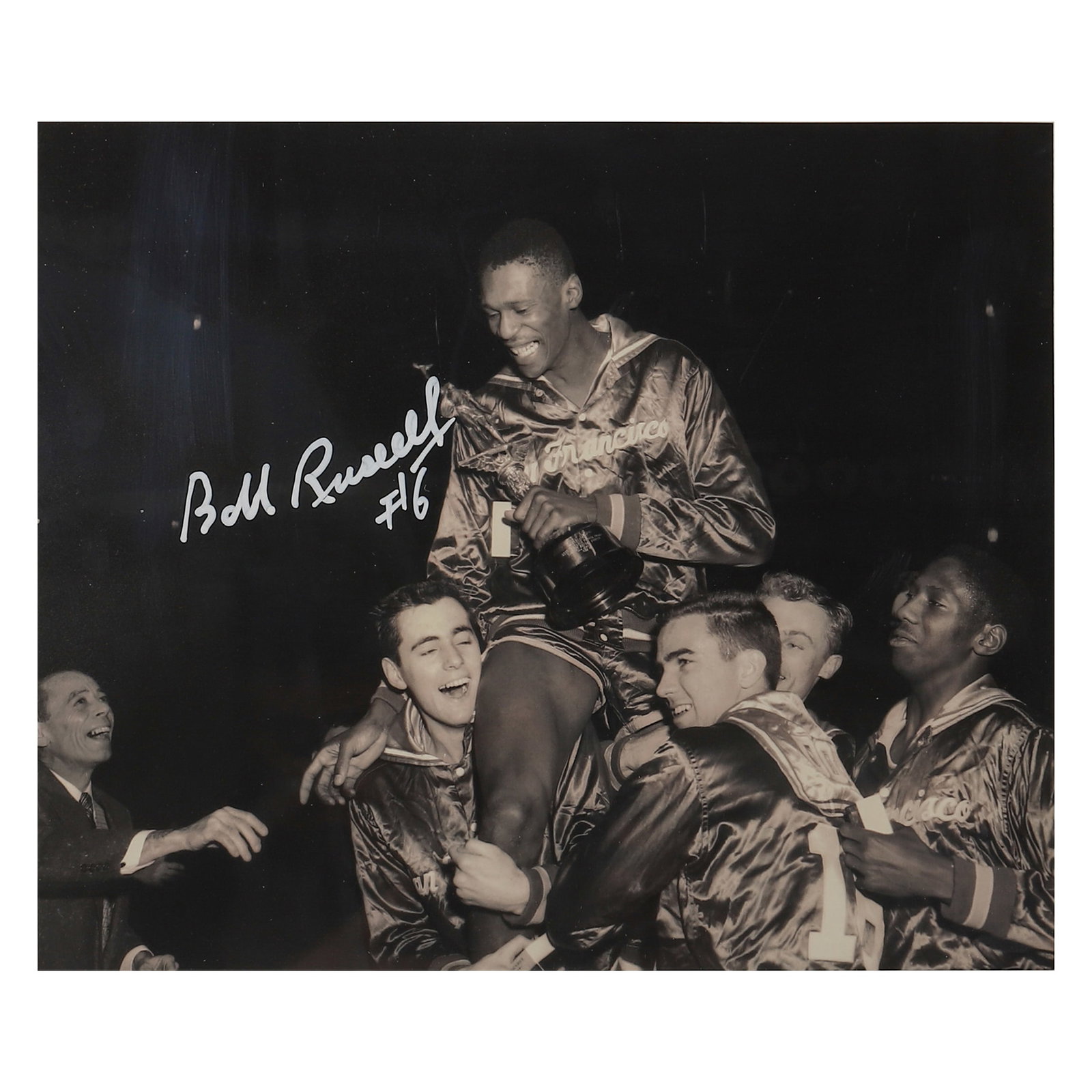 BILL RUSSELL NCAA CHAMPIONSHIP CELEBRATION PHOTOGRAPH: Title: Bill Russell NCAA Championship Celebration Photograph Materials: Gelatin silver print, mounted on board Signature: Signed "Bill Russell #6" in white marker on the left side of the photograph