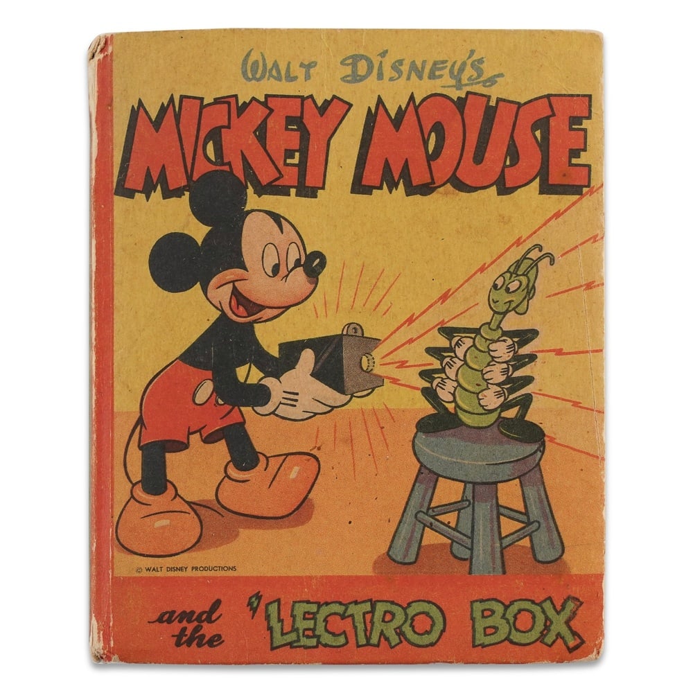 WALT DISNEY SIGNED "MICKEY MOUSE AND THE 'LECTRO-BOX" BOOK: 3 5/8 x 4 1/2 in (9.2 x 11.4 cm) Provenance and Authentication: According to the Letter of Authenticity (LOA) and Certificate of Authenticity (COA) provided by the consignor, this collectible was subj
