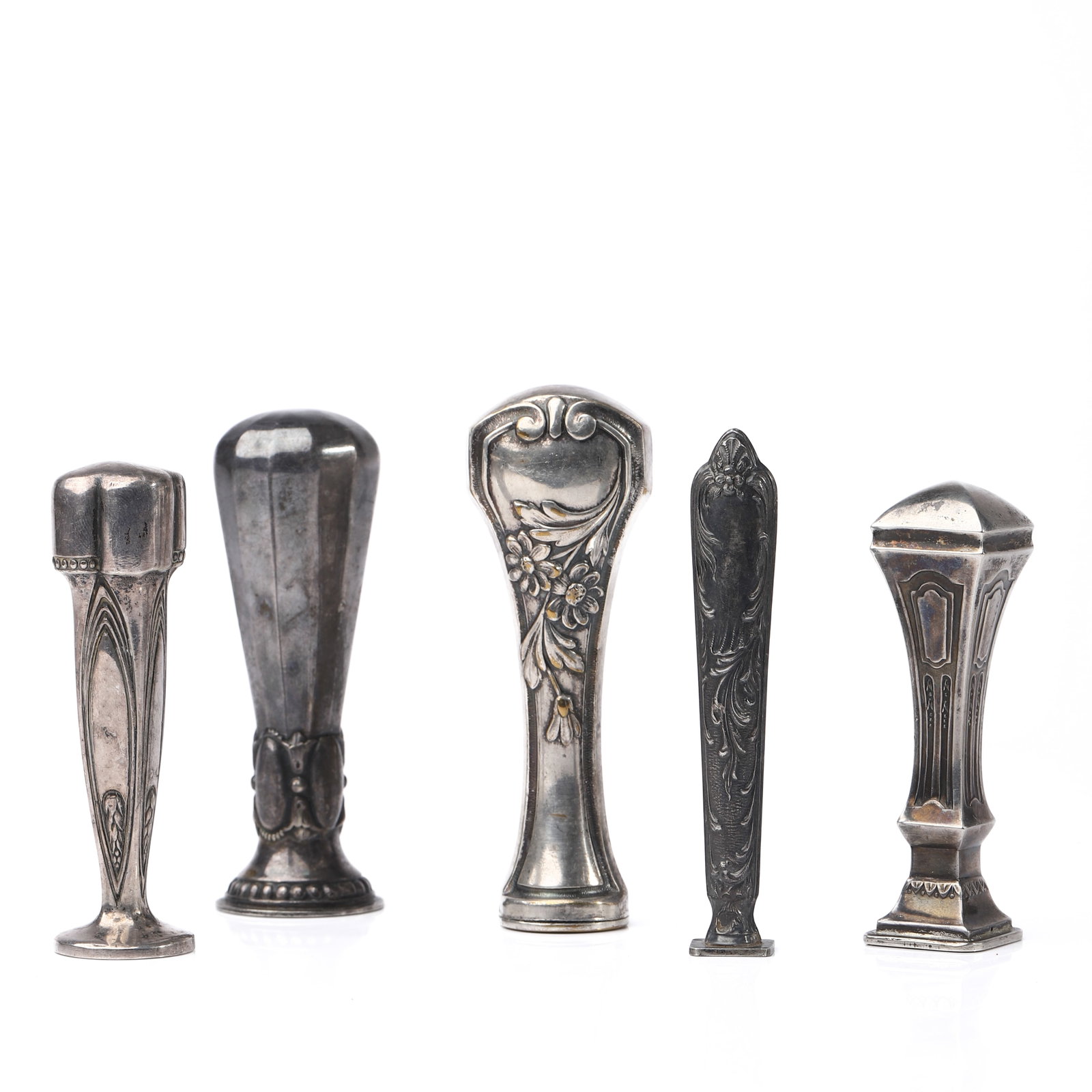 A SET OF FIVE ANTIQUE SILVER-TONED WAX SEAL STAMPS: Dimensions tallest 3 5/8 in (9.2 cm); smallest 3 1/32 in (7.7 cm); total weight approx. 125.6 g Description This assembled group comprises five antique silver-toned wax seal stamps, each with