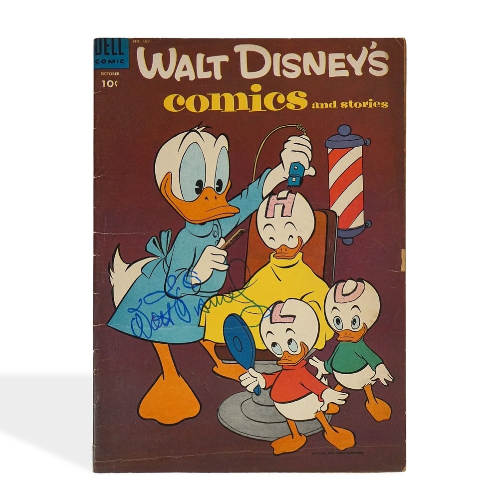WALT DISNEY SIGNED WALT DISNEY'S COMICS AND STORIES: 10 1/4 x 7 3/8 in (25.9 x 18.6 cm) Provenance and Authentication: According to the Letter of Authenticity (LOA) and Certificate of Authenticity (COA) provided by the consignor, this collectible was