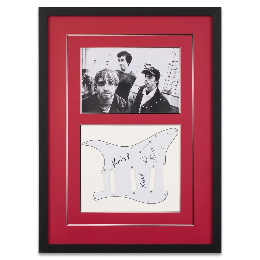 NIRVANA FULLY SIGNED GUITAR PICKGUARD: Framed Dimensions: 28 3/4 x 21 in (73.1 x 53.2 cm) Provenance and Authentication: According to the Letter of Authenticity (LOA) and Certificate of Authenticity (COA) provided by the consignor, this