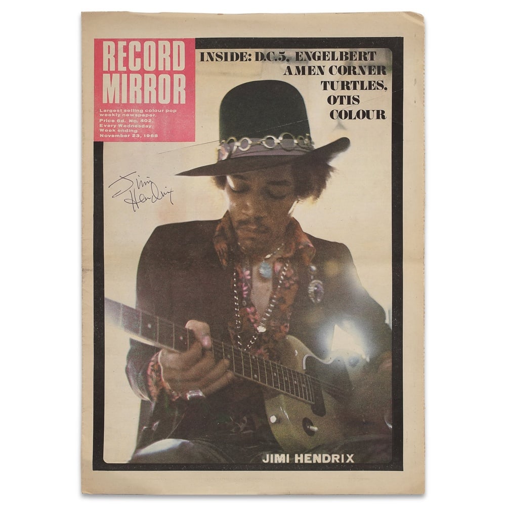 JIMI HENDRIX SIGNED "RECORD MIRROR" MAGAZINE: 11 3/8 x 16 1/8 in (29 x 41 cm) Provenance and Authentication: According to the Letter of Authenticity (LOA) and Certificate of Authenticity (COA) provided by the consignor, this collectible was