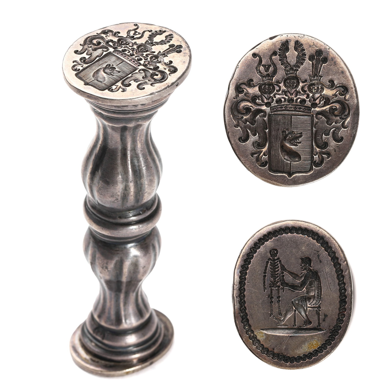 ENAMELED SILVER DOUBLE-FACE SEAL HANDLE WITH COAT OF ARMS AND SKELETON MOTIF.: Dimensions: Height: 3 5/8 in. (9.2 cm), Weight: 3.8 oz. (108.9 g) Description: A finely cast antique silver wax seal with a fluted baluster-form handle, featuring two distinct engraved matrices. One e