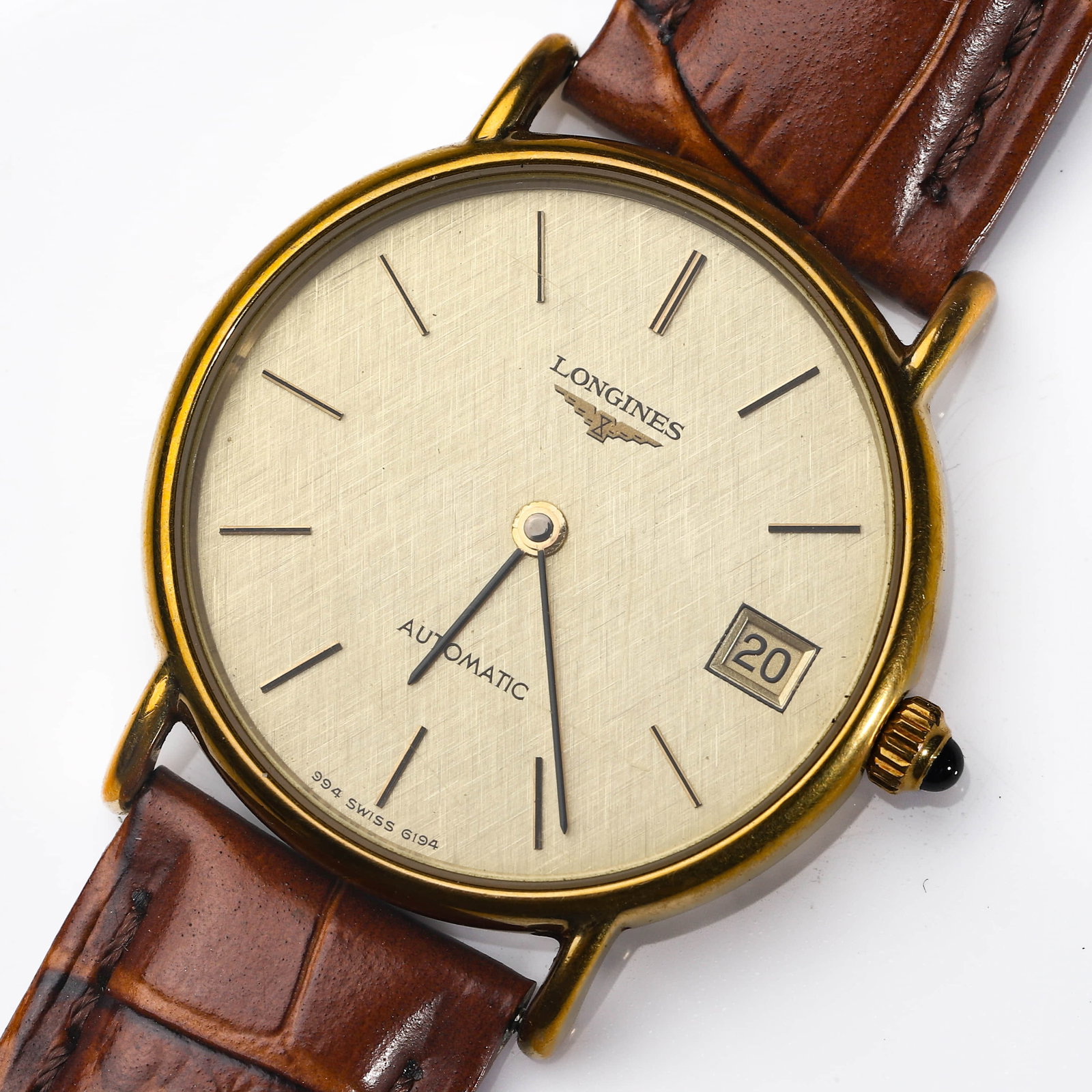 LONGINES GOLD-TONE AUTOMATIC DATE WRISTWATCH: Dimensions Case diameter: 1 27/64 in. (36 mm); overall length approx. 9 1/4 in. (23.5 cm). Description A classic Longines automatic wristwatch, featuring a finely textured champagne dial signed