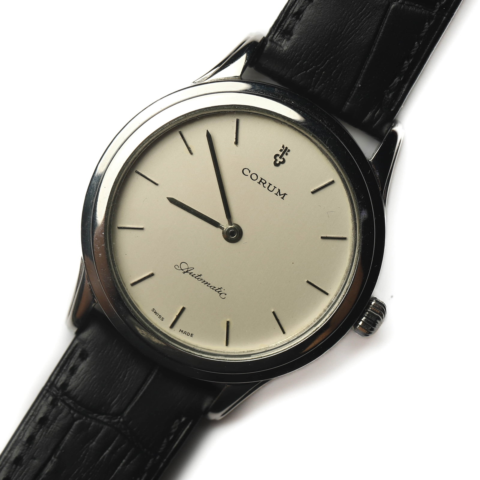 CORUM AUTOMATIC GENTLEMAN'S WRISTWATCH: Dimensions Case diameter: 1 1/2 in. (3.84 cm) Overall length: 9 5/16 in. (23.6 cm) Weight: 44.7 g Description A Corum gentleman's automatic wristwatch featuring a clean ivory dial with applied baton