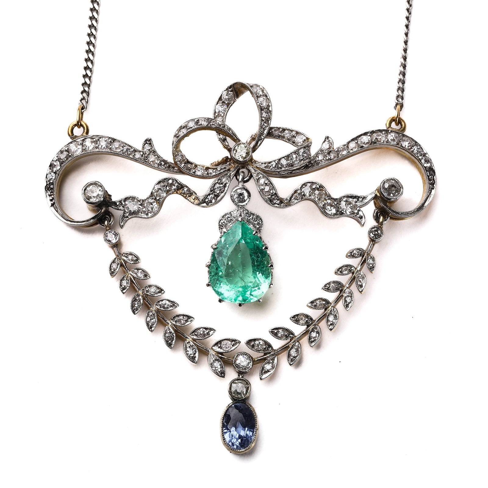 DIAMOND AND EMERALD GEMSTONE NECKLACE: Length: 5 cm (1 15/16 in.); Width: 5.4 cm (2 1/8 in.); Gemstone Size: 12 × 5.8 mm (0.47 × 0.23 in.); Weight: 10 g This stunning necklace features a beautifully cut emerald gemstone, suspended in an
