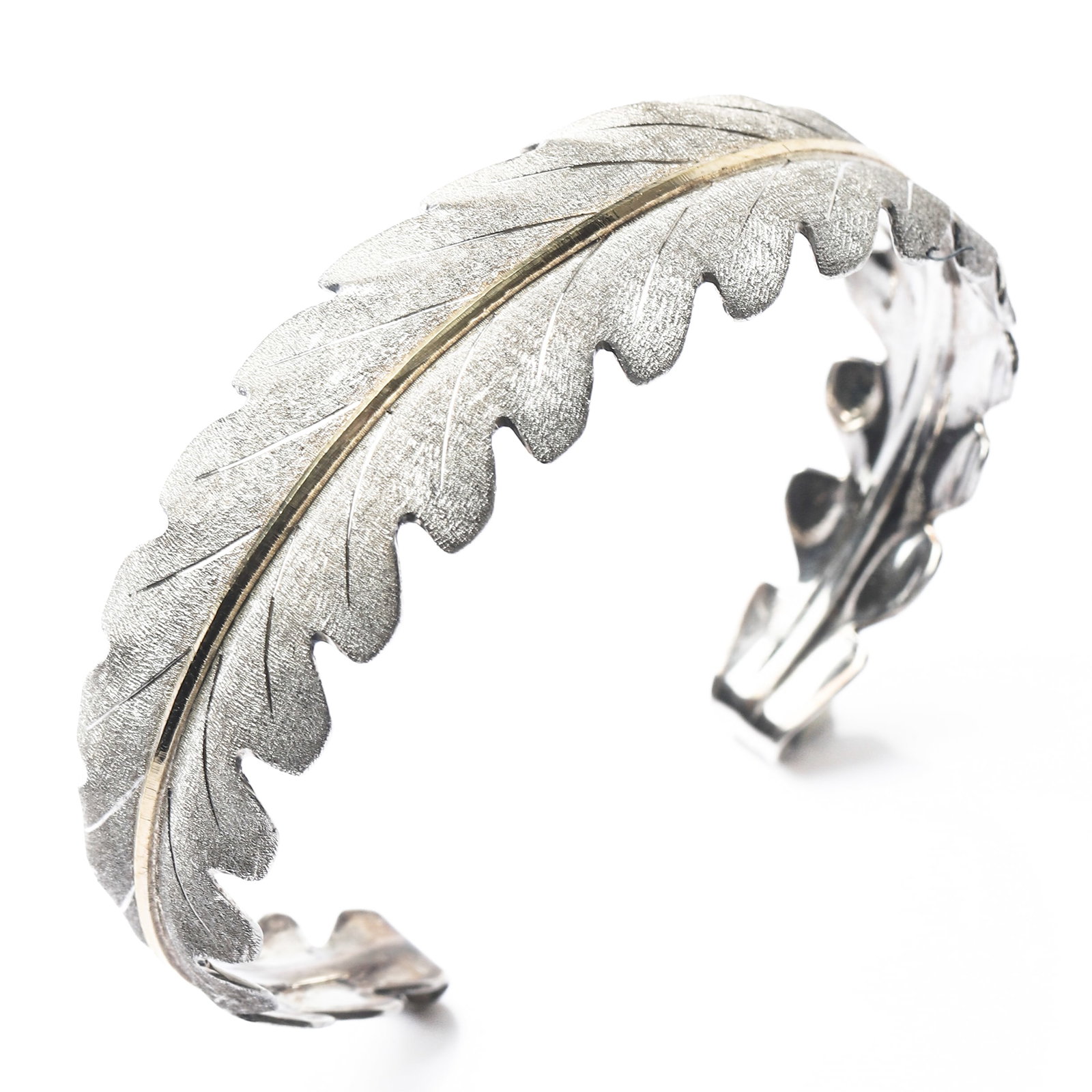 FEDERICO BUCCELLATI GOLD AND SILVER LEAF CUFF BRACELET: Dimensions Inner diameter: 2 1/2 in. (6.35 cm); weight: 23.5 g. Description: An antique leaf-form cuff bracelet by Federico Buccellati, handcrafted in a sophisticated combination of 18k gold and