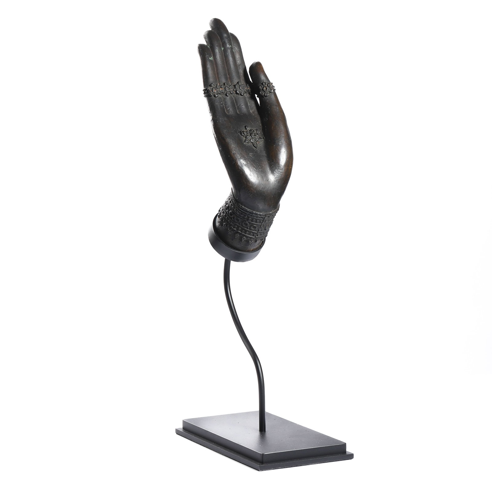 A BRONZE SCULPTURE OF A BUDDHA HAND: Dimensions: Height: 15 3/4 in (40 cm) Description: A finely cast bronze sculpture depicting the right hand of Buddha in abhaya mudra (gesture of reassurance and blessing), elegantly raised with the pa