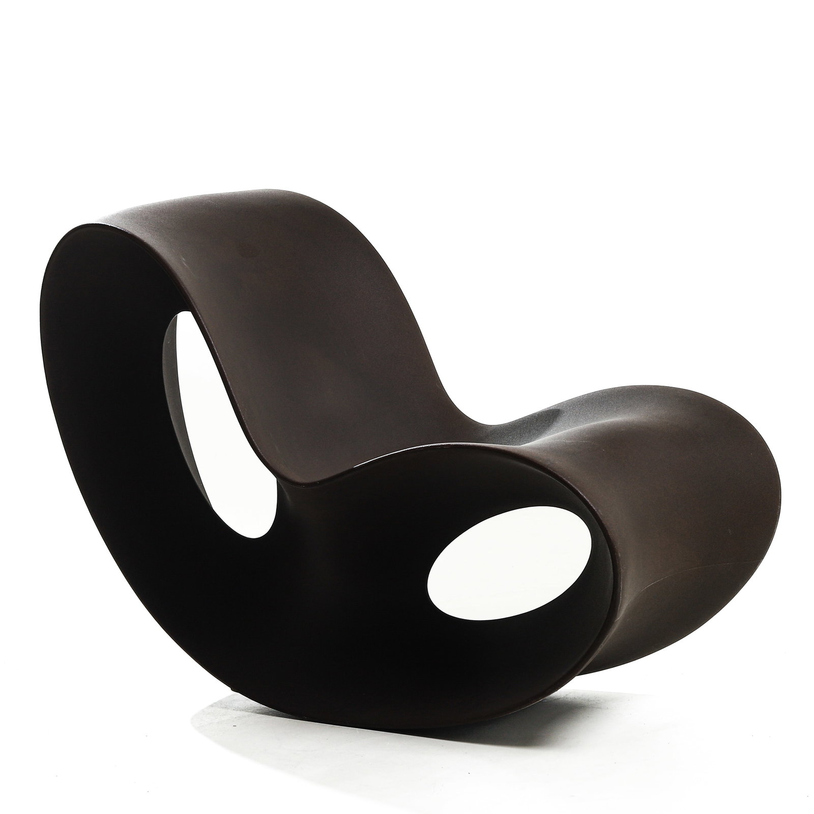 A CONTEMPORARY SCULPTURAL ROCKING CHAIR: Dimensions Height 30 7/8 in (78.5 cm); Width 22 1/2 in (57 cm); Length 43 1/4 in (110 cm). Description Of bold sculptural form, the chair is crafted in a continuous undulating silhouette with fluid cu