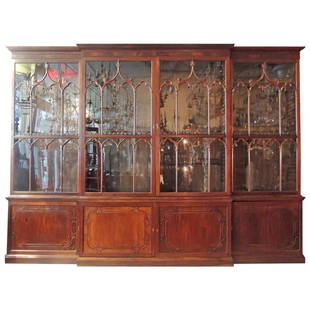 Monumental 19th C Irish Chippendale Mahogany Breakfront: This monumental 19th Century Mahogany Ivy House Estate Irish breakfront/bookcase features four glass doors with Gothic arches and designs on each panel. The bottom sections are decorated with Chinese