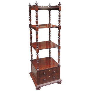 19th C English Regency Mahogany Library Stand: An early 19th century Channel Island library bookcase or étagère features solid mahogany turnings, three shelves, a finished scalloped gallery, and two drawers on four bun feet with