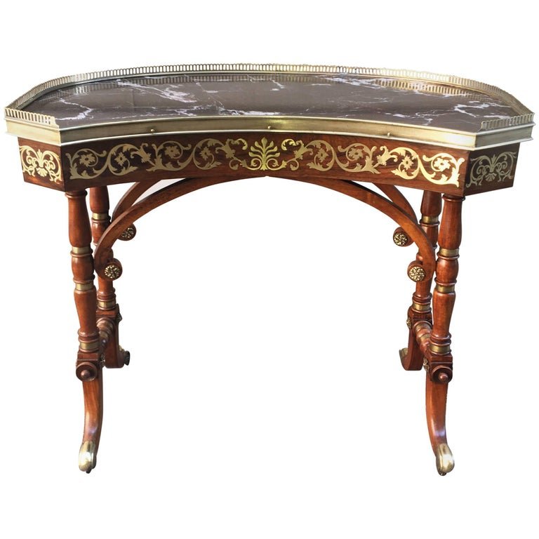 Early 19th Century English Regency Rosewood Library or Dressing Table: An early 19th century English Regency rosewood library/dressing table attributed to John McLean. This table is kidney shaped with floral designed inlaid brass (Boulle inlay). Marble top surrounded by