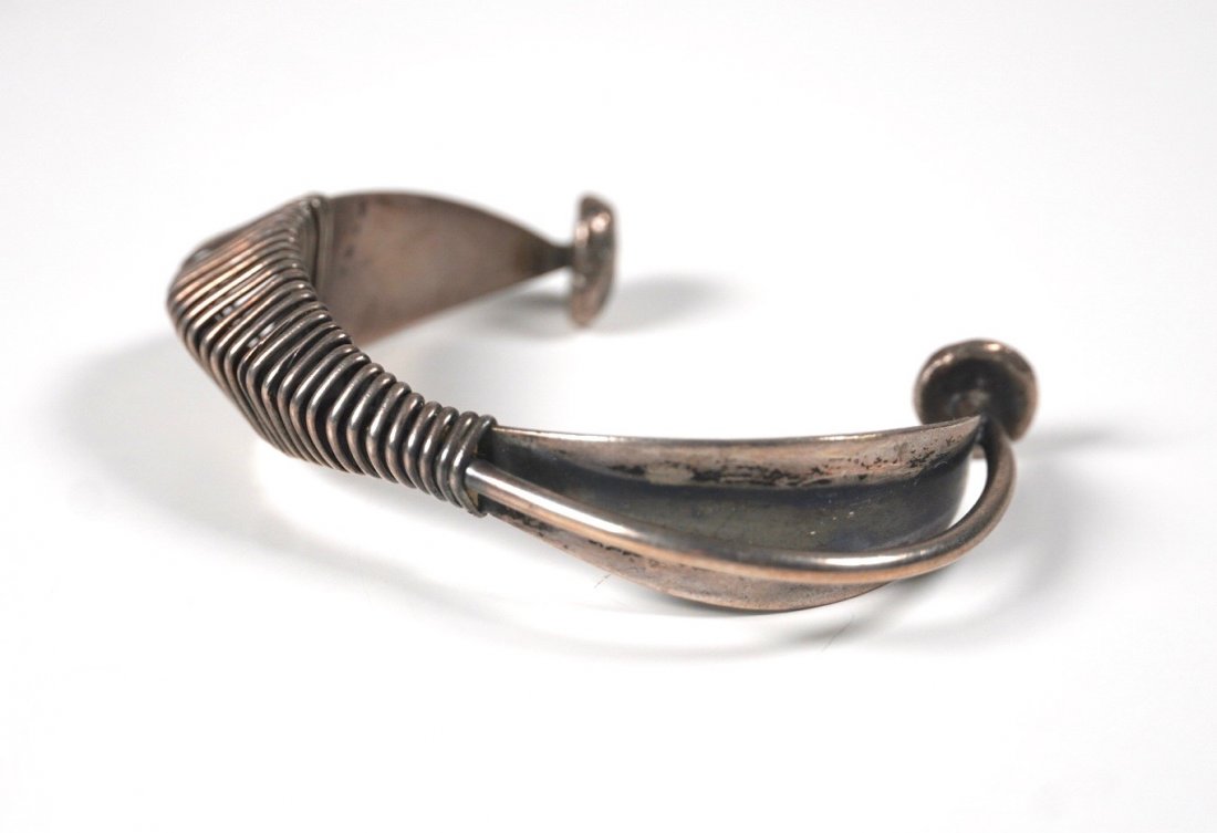Modernist Sterling Silver Bracelet by Ed Wiener: Silver bracelet by New York studio jewelry maker Ed Wiener (1918-1991). A Modernist bracelet constructed of a thick sterling silver band with thin sterling silver wire wrapped around it to create the