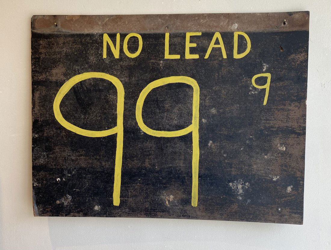 Rustic Folk Art Hand Painted Gas Station Sign: Vintage handcrafted gas station signage on board. The sign dates to pre 1975 when leaded gasoline was phased out. The state states â€œNo Lead 99.9”, painted in yellow paint on a black fiberb