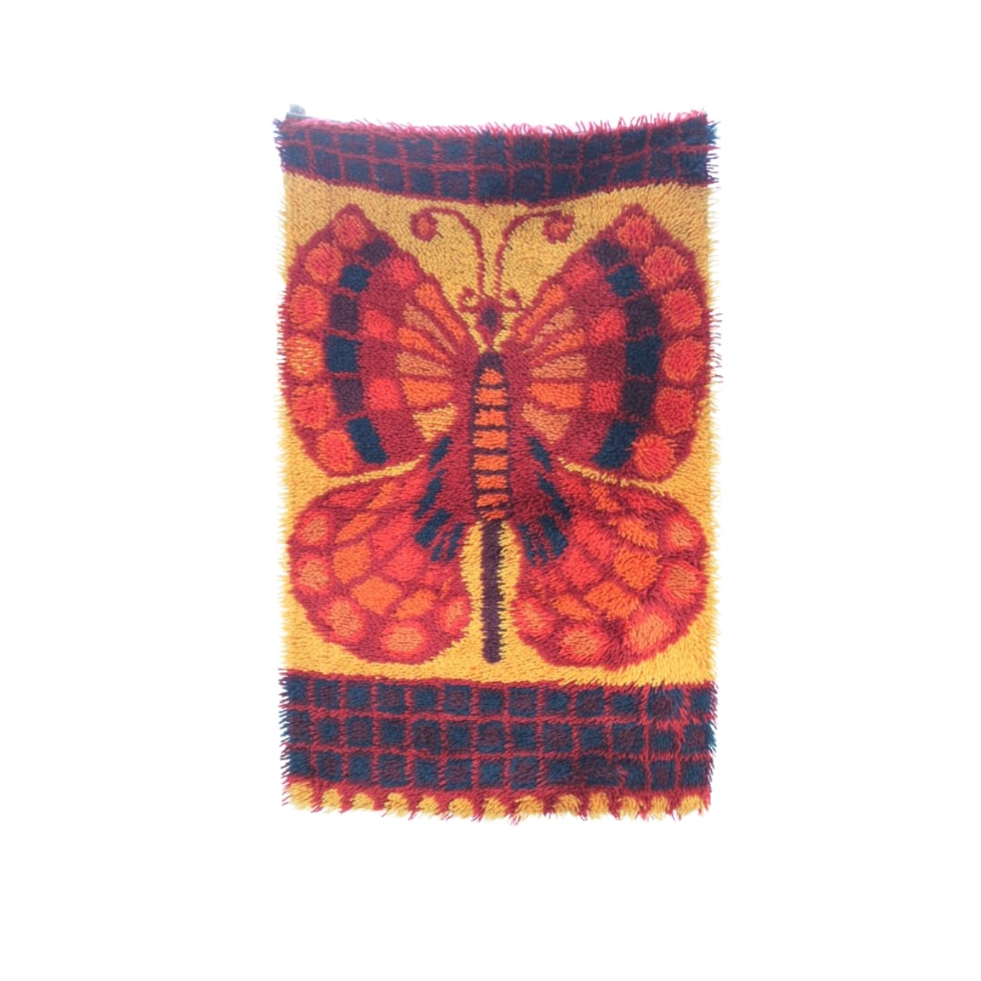 EGE RYA 'Butterfly" Hanging Smyrna Carpet, Denmark: EGE RYA 'Butterfly" Hanging Smyrna Carpet, Denmark c. early 1970s. Hand tied wool wool carpet. No stains No discoloration. Has all its orginal hangers Colors are bright and no snags Measures 44" x 27"