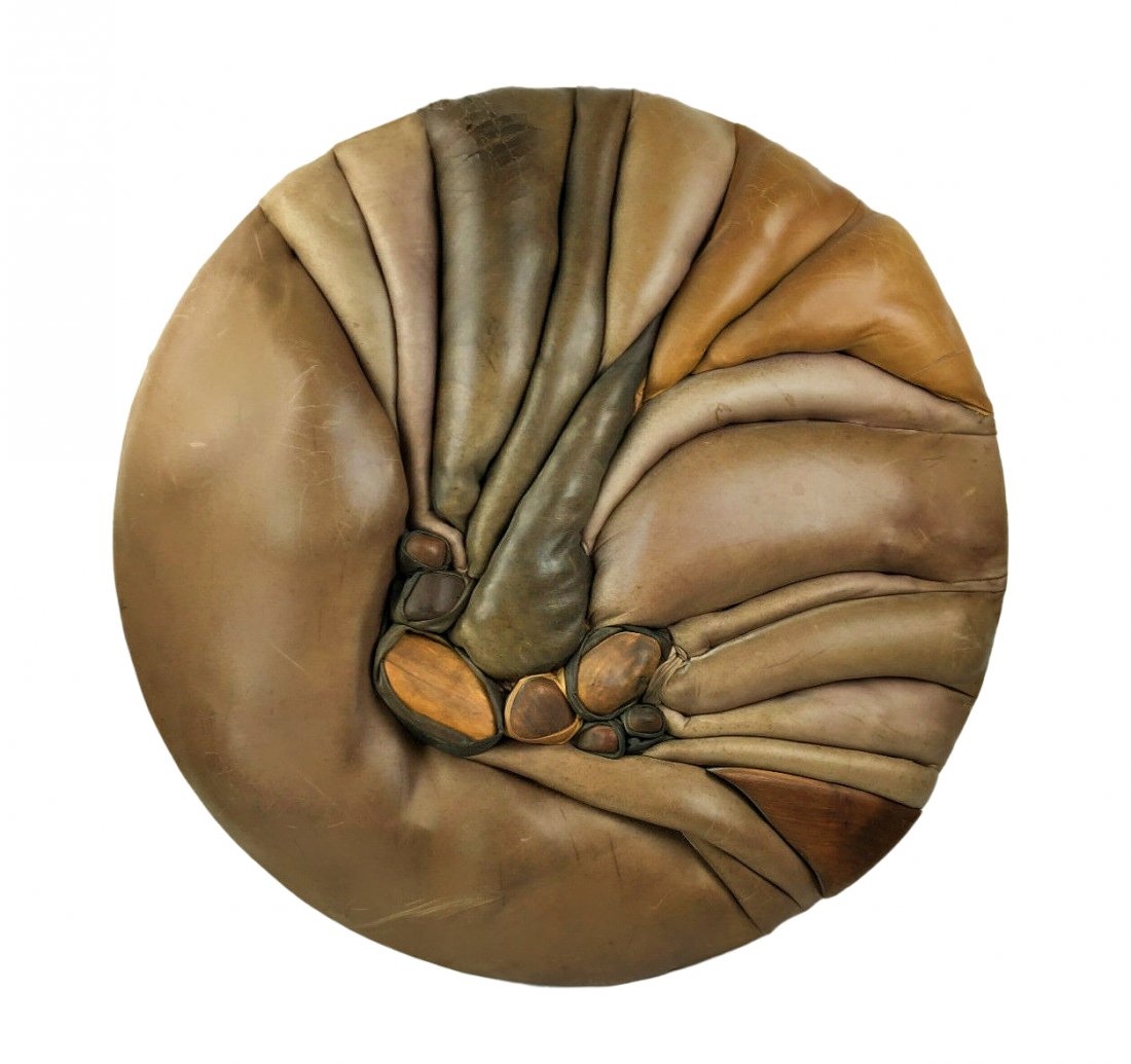 Vintage Large MCM Abstract Wall Art Leather & Wood: Large abstract dimensional leather and wood wall art sculpture by unknown artist. Swirling tucked leather in brown shades over wood. Some edge wear and distress to leather. Measures at 36" diameter x