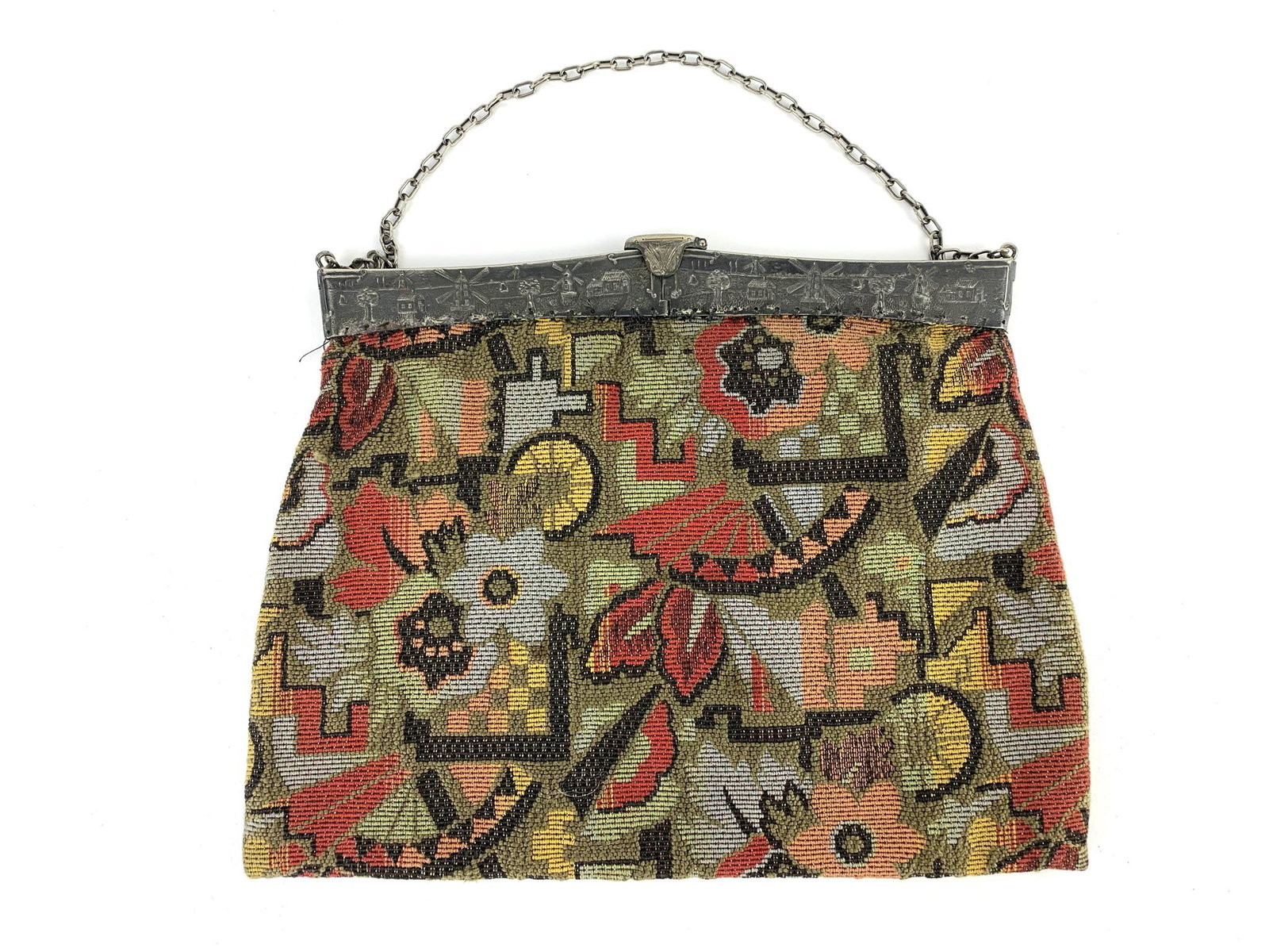 Antique Tapestry Windmill Purse Handbag: Antique tapestry purse with metal or pewter clasp adorned with windmills. Pattern appears to be Art Deco. Measures 9 1/4" x 11" with a 5 1/2" chain drop.