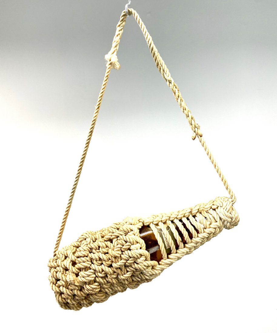 Nautical Sailor Made Knotwork Rope Hanging Bottle: Vintage rope covered wine bottle. Hand knotted, sailor made. From local collector of marine and nautical antiques. Measures 13"t x 4"w. In house domestic shipping $25.