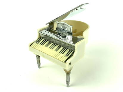 Vintage Clinton Piano Table Lighter Japan: Vintage Made in Occupied Japan Lighter in the shape of a grand piano. Measures 4" x 3 1/2" x 2 3/4".