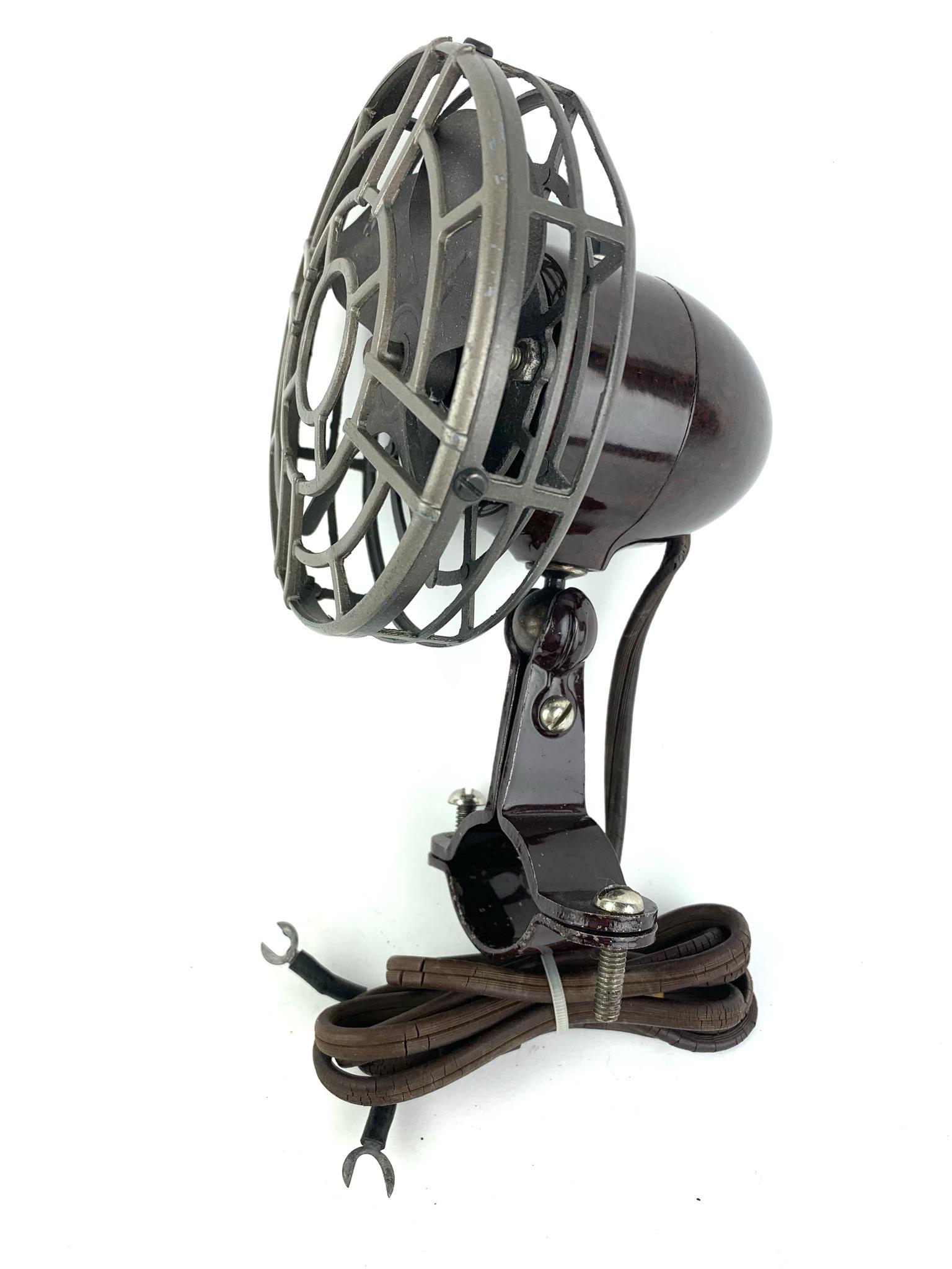 Art Deco Bakelite Bullet Clamp Fan: Brown & Black Bakelite bullet shape clamp fan by unknown maker or designer. Measures 7 1/4" x 4 1/2"