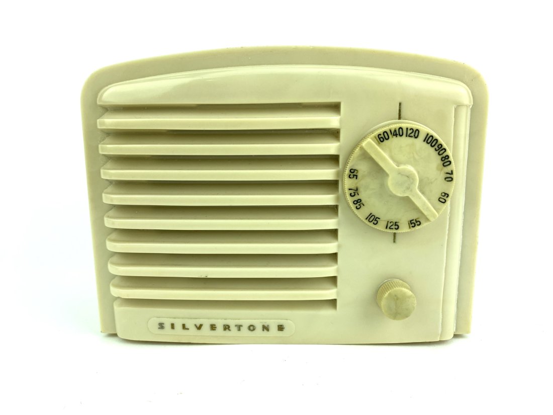 White Bakelite Silvertone Tube Radio: White case with white knobs. Silvertone on base of front. Measures 4 1/2" x 6 1/4" x 4 1/2"