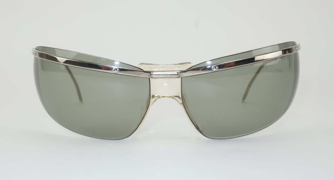 Renauld Spectaculars French Wrap Around Sunglasses, 1960's: 1960's Renauld of France wrap around sunglasses...a favorite style of race car drivers, skiers and airline pilots as well as celebrities Elvis Presley and Jacqueline Kennedy Onassis. The silver metal 