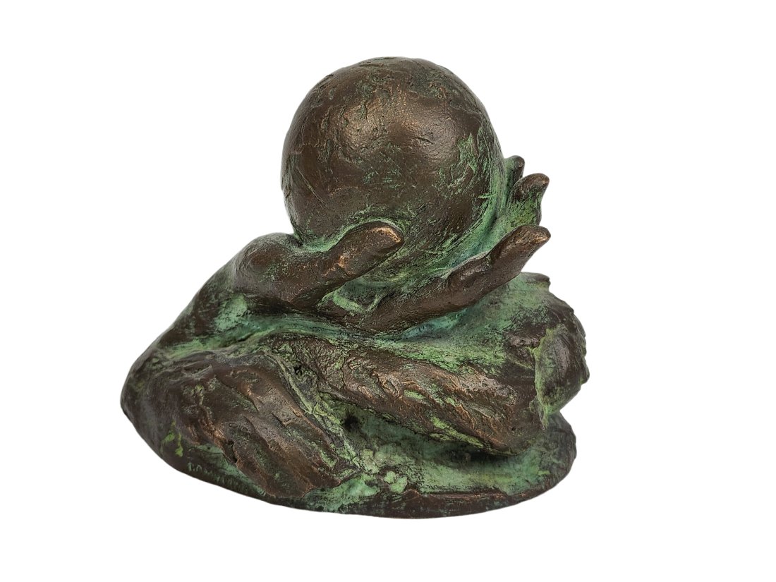 1976 Mara Dominioni Bronze World in Hand Sculpture: Bronze sculpture depicting the world in a hand with waves by Mara Dominioni signed along base. Etched 1976 underneath. Measures 4 1/4" x 3 1/4" x 3 1/2"