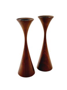 Rude Osolnik Modern Candlestick Pair: Pair of weighted tapered candlesticks in walnut designed by Rude Osolnik. Measure 8" x 2 1/2" each with a 1" opening.