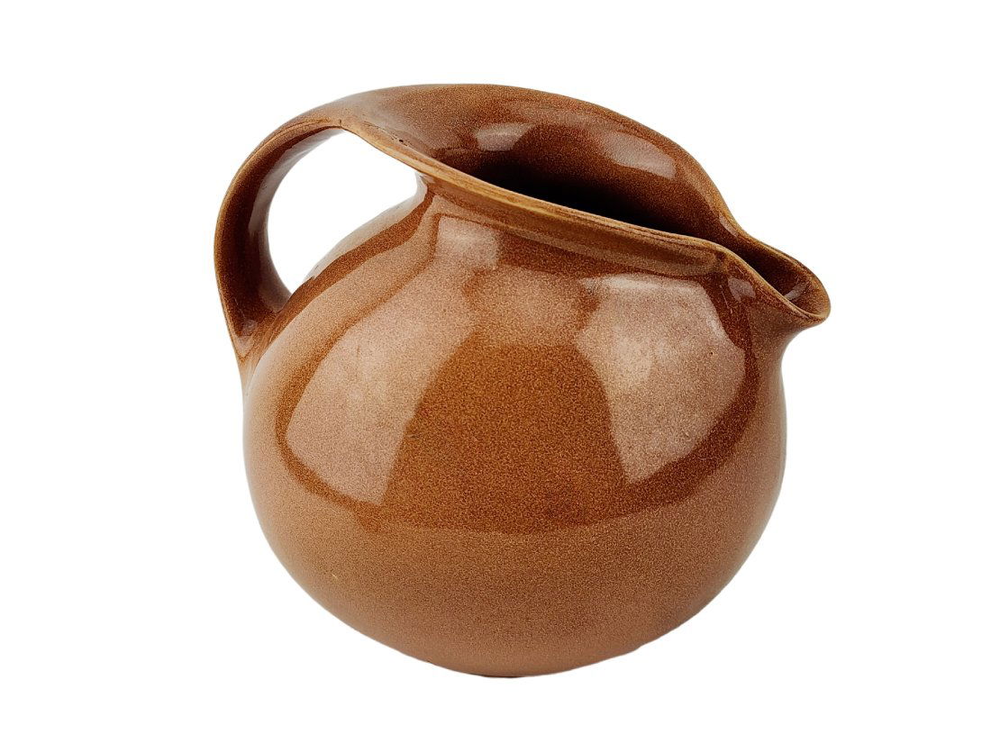 Vintage Russel Wright for Sterling China Pitcher: Vintage brown ceramic pottery pitcher by Russel Wright for Sterling China. Stamped on bottom. Measure 7" x 8" x 7" with 3" opening.