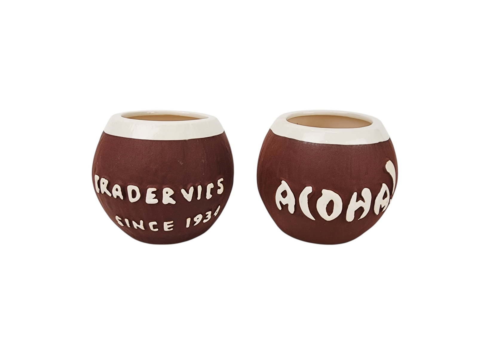 Pair of Trader Vic's Aloha Coconut Tiki Cocktail Mugs: Vintage pair of Trader Vic's ALOHA Coconut shape Tiki Mugs, stamped on bottom. Measure 4" x 4 1/2" each.