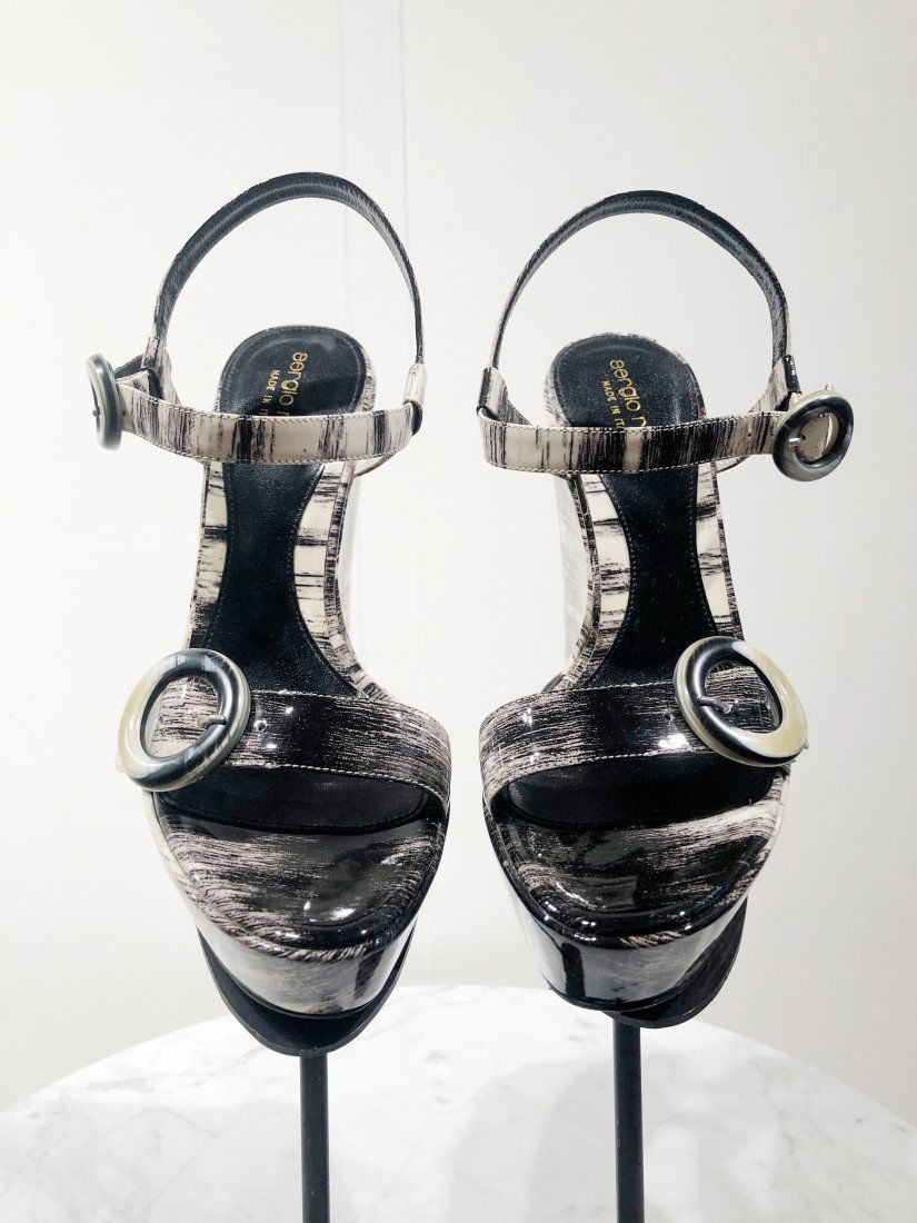 Sergio Rossi Leather Platform Sandals in Graphic B&W: Sergio Rossi leather platform sandals in a graphic black and white brush stroke pattern. Resin faux horn buckles.