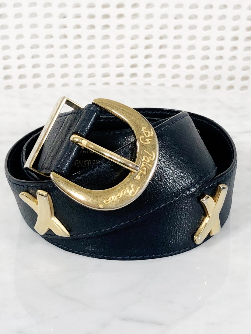 1980s Paloma Picasso Gold "X" Belt In Black Leather: 1980s Paloma Picasso gold "X" belt in black leather. Signature abstract X logo buckle. Marked a size small and measures 27-28 inches max.
