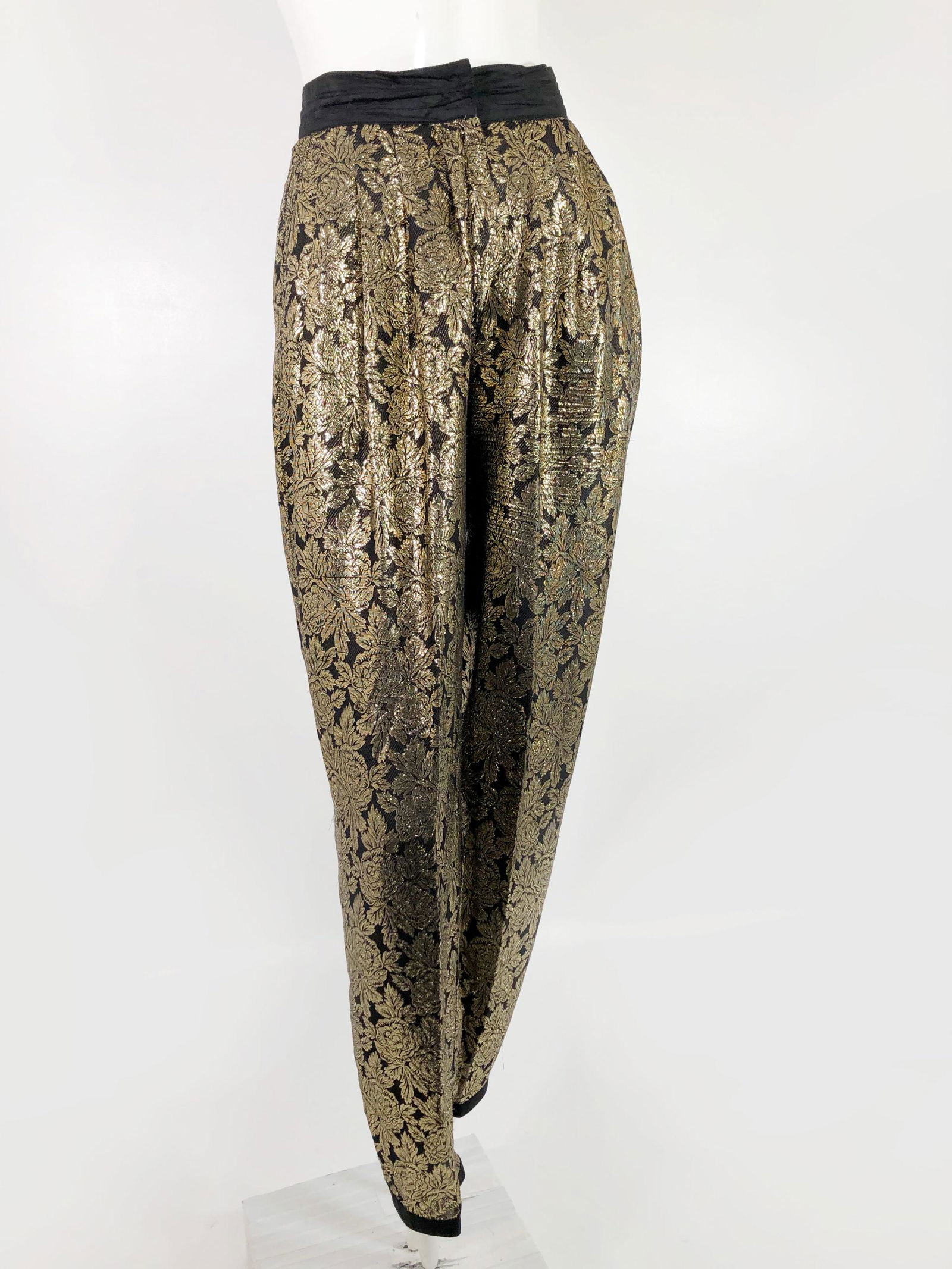 1980 Gianni Versace Black and Gold Lame Slacks: 1980 Gianni Versace black and gold lame slacks with black silk waistband. Two side pockets, center front zipper. Labeled size 42. US size 6.Fits a US medium. See measurement card for exact fit.