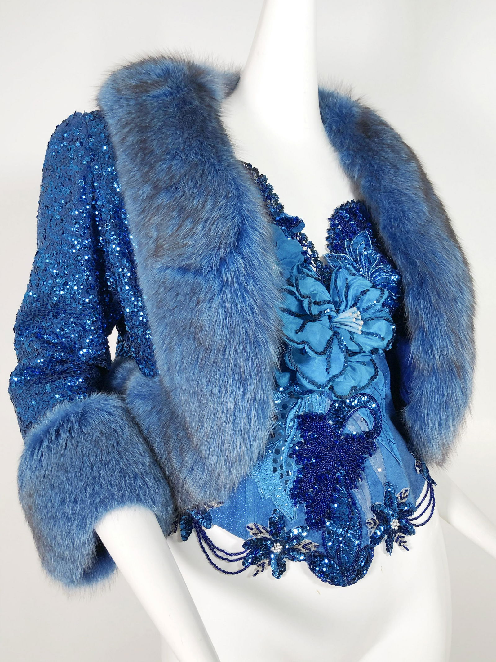 Vintage Cobalt Sequined Fox Fur & Corset Ensemble: 1980 Blue suede "Natasha" corset with embellished sequined, beaded, and embroidered appliques. Adjustable Marked US size Medium. 1960 Blue sequined blue dyed fox fur trimmed jacket. Fits a size 2-4. 1