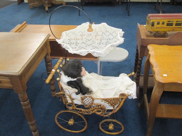 Victorian Wicker Pram with Parosol: Antique wicker pram with parasol measures 49"H x 29"W.Item in good overall condition, some pieces are loose and comes with baby doll.