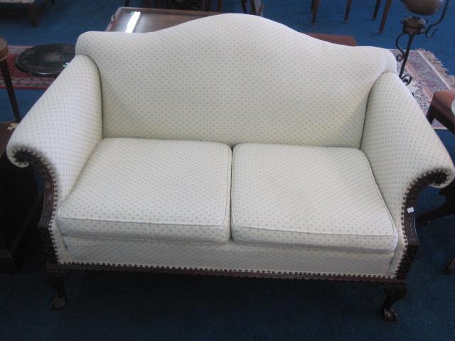 Chippendale Style Settee: Vintage 1940's settee sits on carved legs with ball and claw feet. Fabric shows light wear and measures 64"W x 34"H x 35"D. Good overall condition.