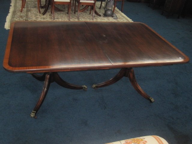 Mahogany Table with Band Inlay: Solid mahogany table with brass feet. Table measures 72"W x 44"D and Includes two 18" boards. Good overall condition with minor wear top top.