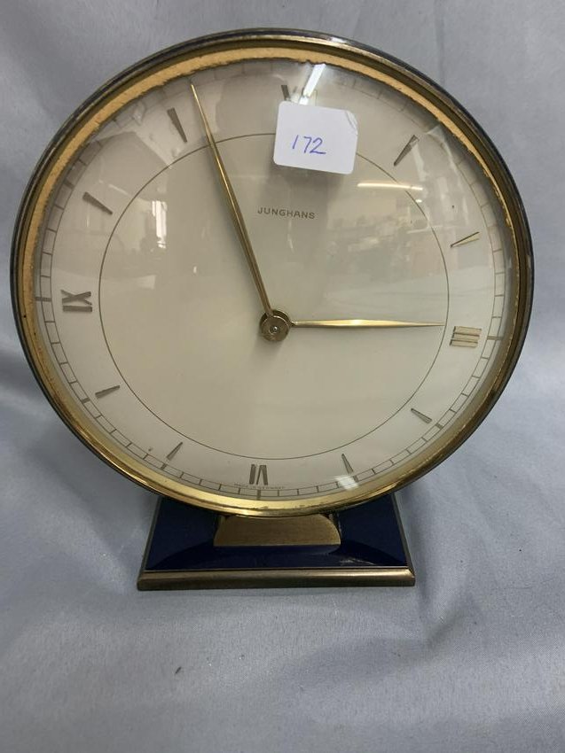 Junghans Clock: Measures 6 1/2"H x 7 1/2"W. Decorated with blue enamel to base and sides. Appears to be over wound, clock starts and stops.